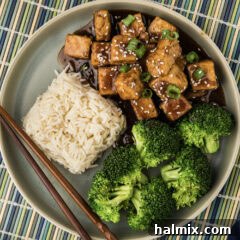 Close up photo of Teriyaki Tofu on a plate with rice and broccoli