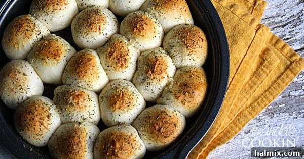 A close up photo of meatball stuffed biscuits in a cake pan.