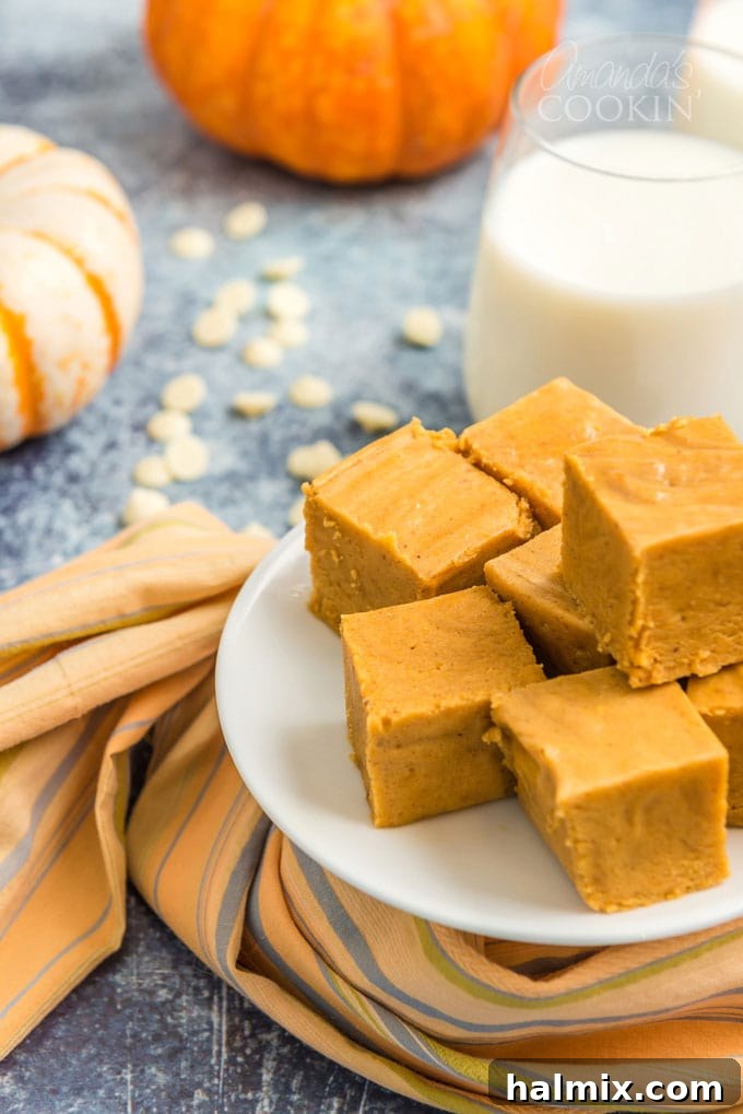 a plate of stacked pumpkin fudge squares, ready to be served