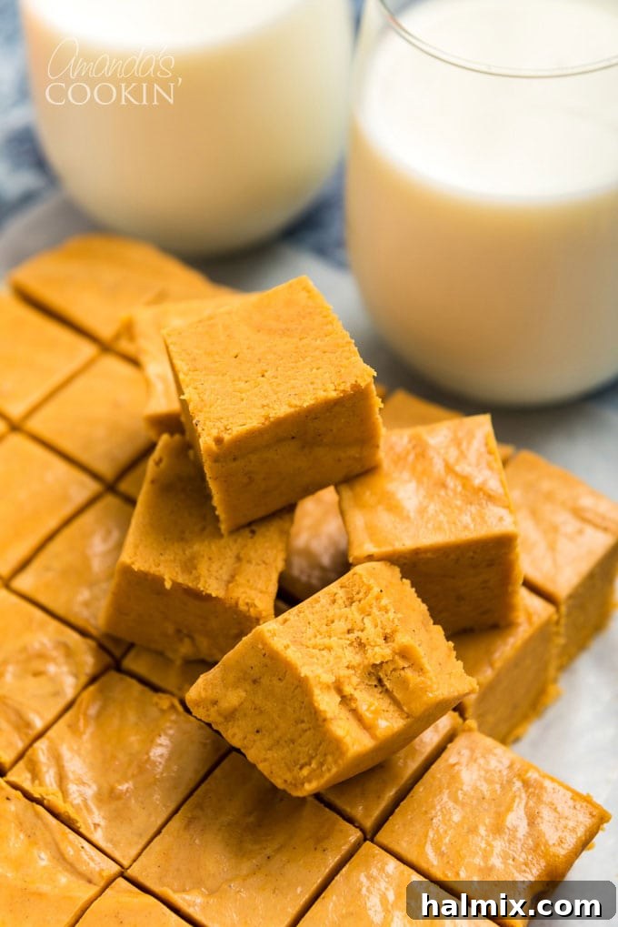 stack of golden pumpkin fudge squares on a wooden surface