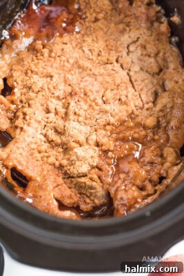 Cozy Crockpot Apple Cobbler 11 apple dump cake that has been cooked in a crockpot