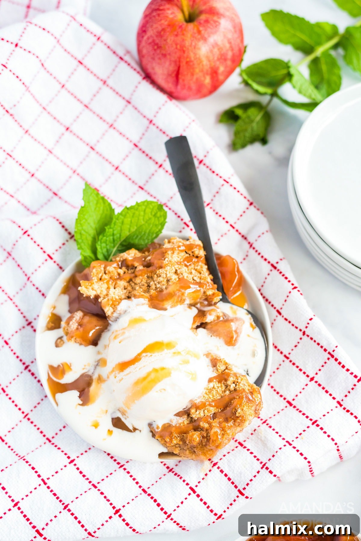 Cozy Crockpot Apple Cobbler 2 crockpot apple cobbler with ice cream on a checkered towel
