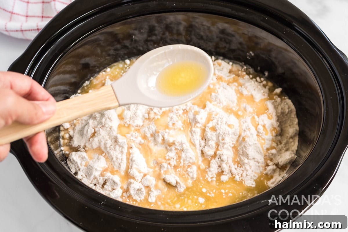 Cozy Crockpot Apple Cobbler 6 adding melted butter to crockpot
