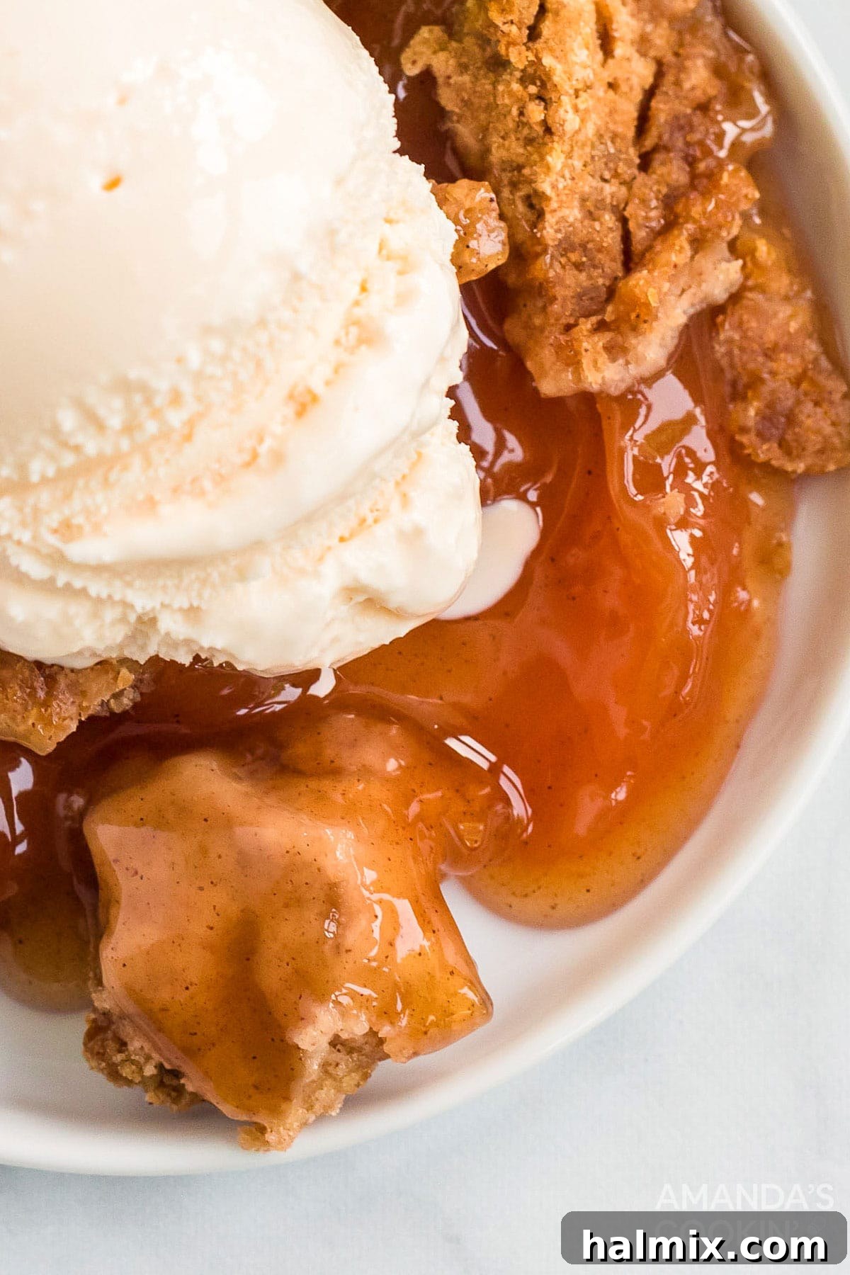 Make crockpot apple cobbler in your slow cooker. This easy crockpot dessert is quick & simple and great any time of year. close up of apple cobbler