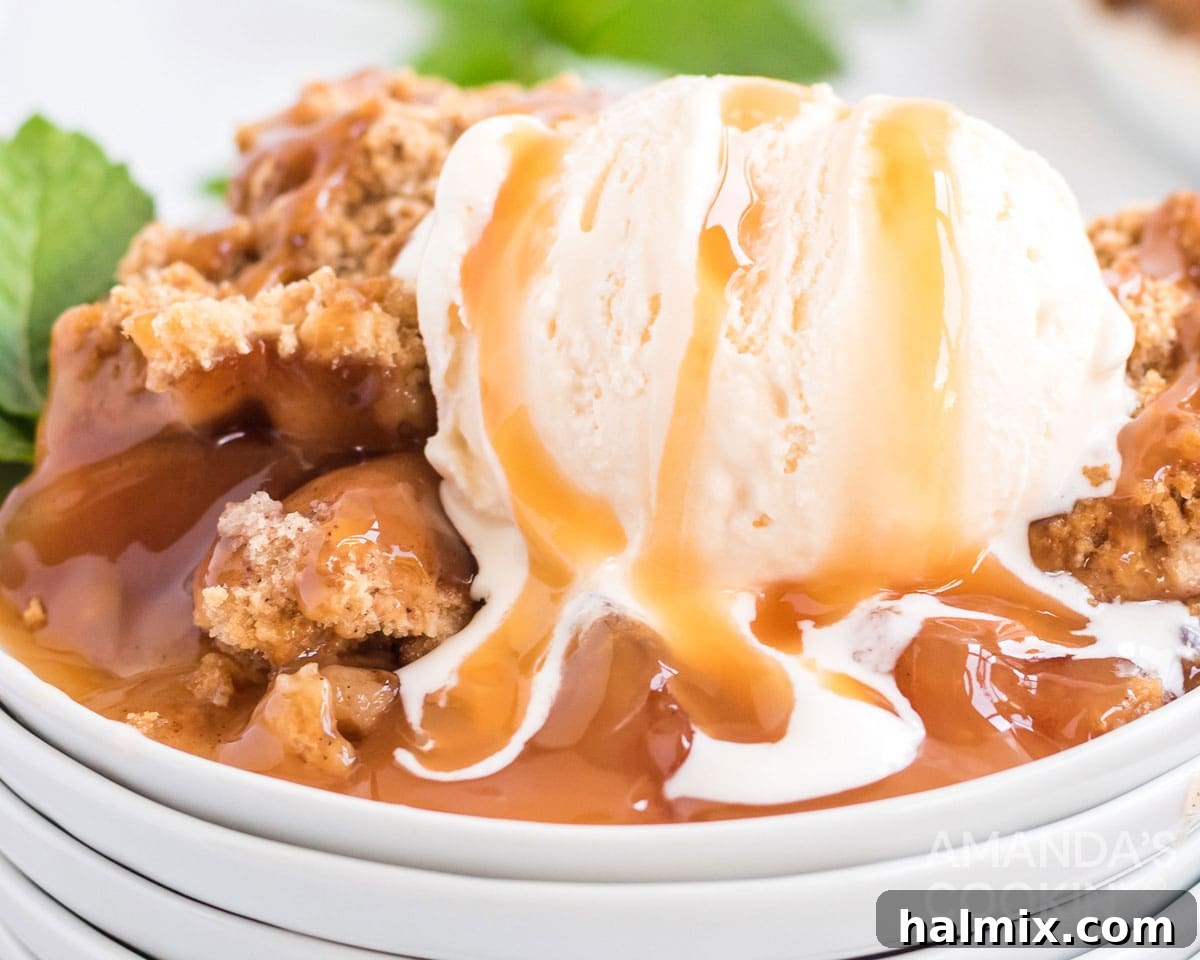 Make crockpot apple cobbler in your slow cooker. This easy crockpot dessert is quick & simple and great any time of year. melting ice cream on crockpot apple cobbler with caramel sauce