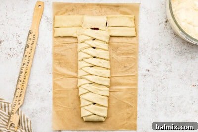 Sweet Braided Morning Pastry 21 folding the end tab of the sectioned dough over the filling