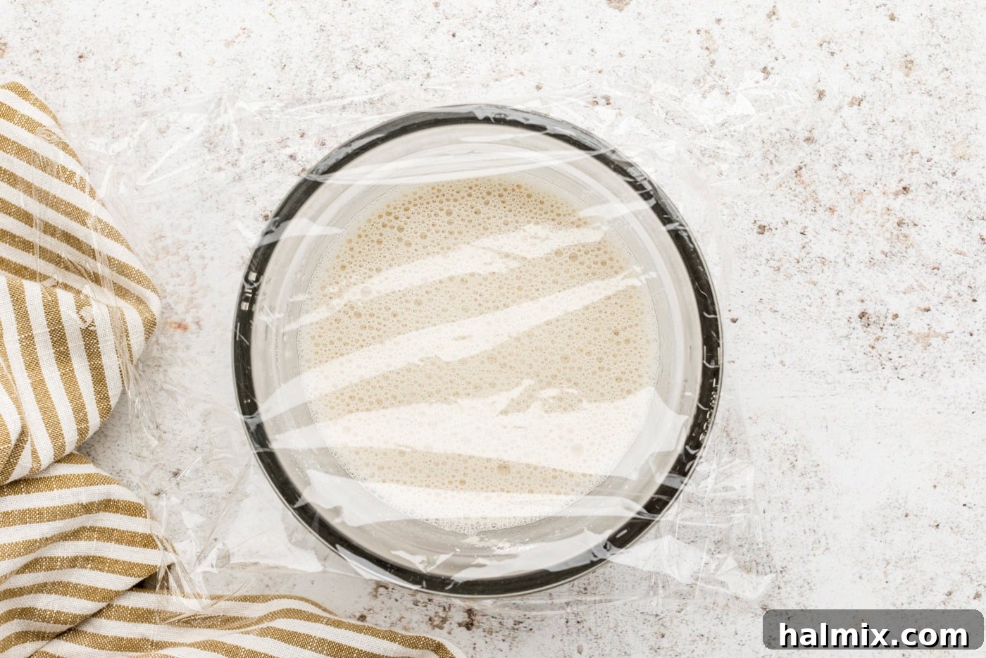 Sweet Braided Morning Pastry 5 sponge ingredients in a bowl covered with plastic wrap
