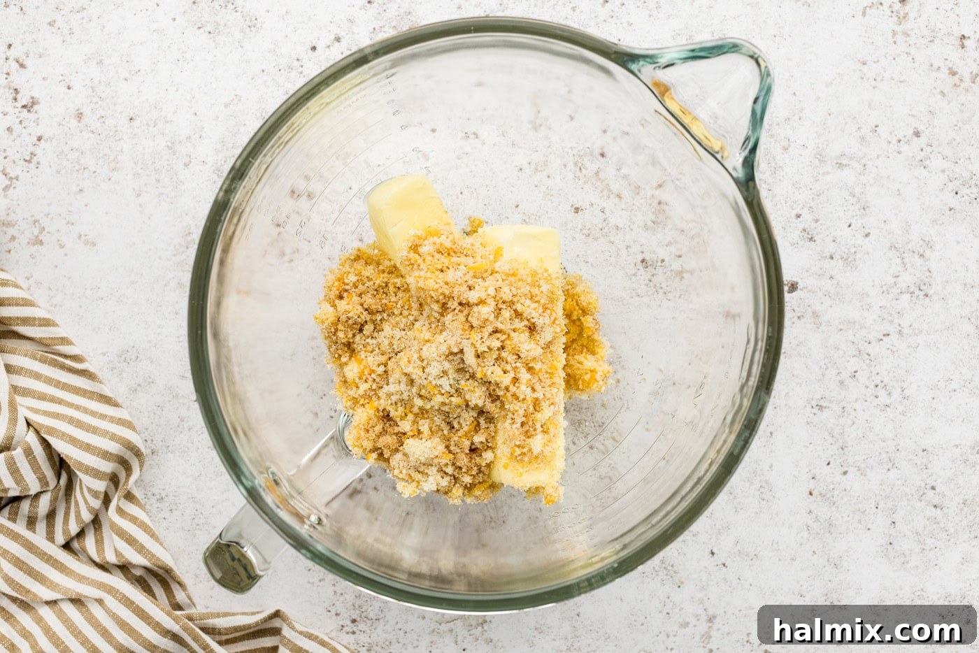 Creamed butter and sugar mixture in the bowl of a stand mixer, appearing light and fluffy.