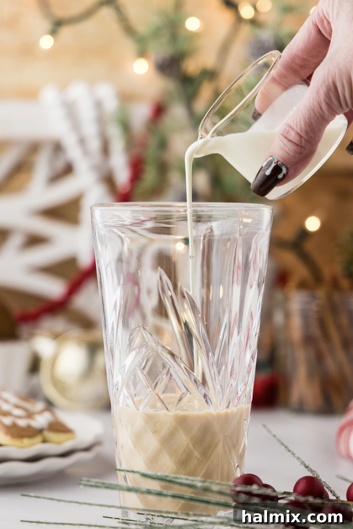 pouring heavy cream into cocktail shaker glass 