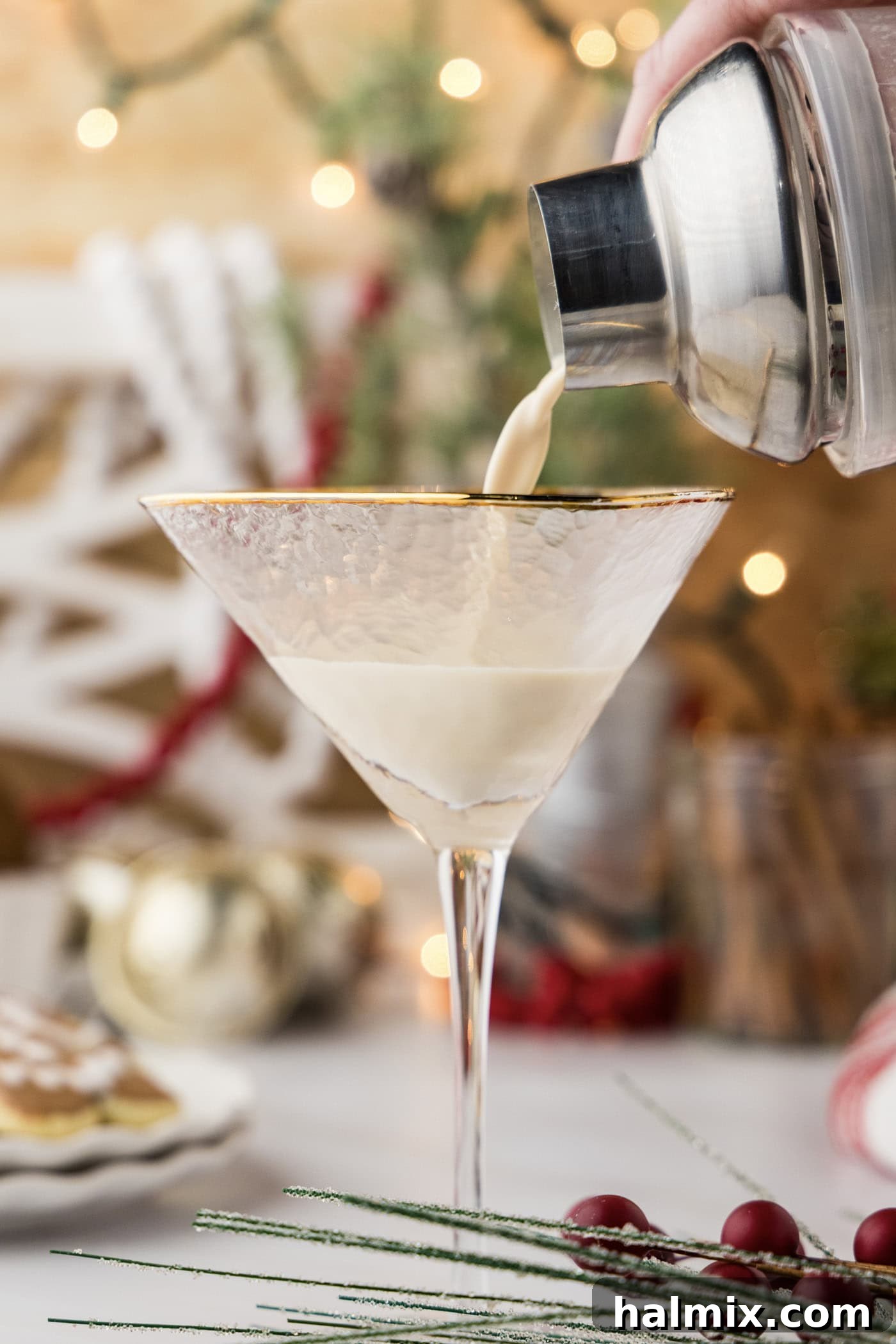 straining gingerbread martini into a martini glass