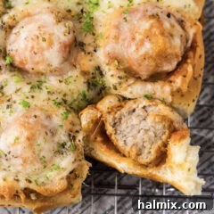 Pocket-Sized Meatball Delights 11 Close up photo of a Meatball Slider with a bite taken out of it, showcasing the delicious filling.