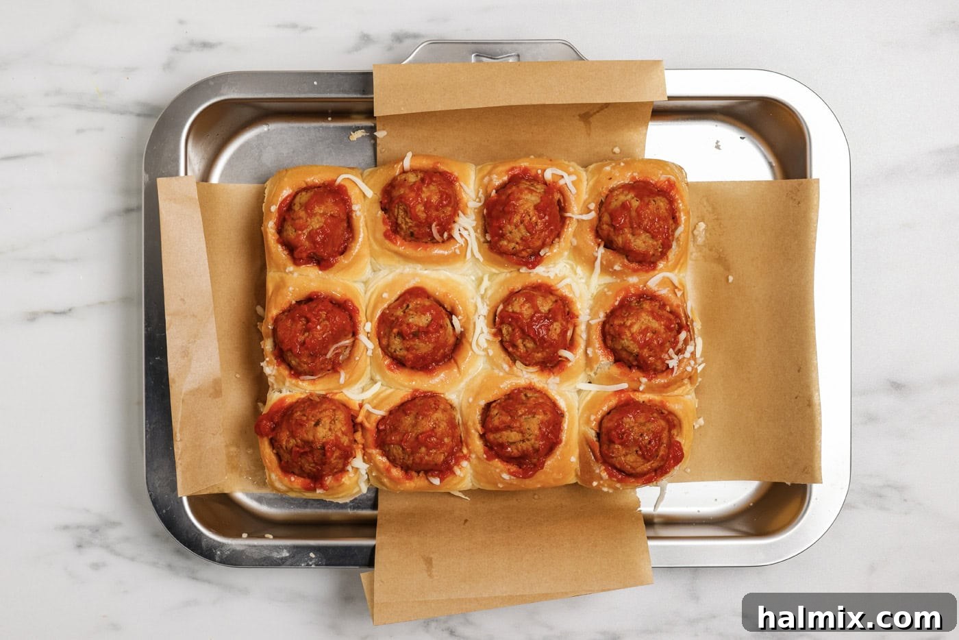 Pocket-Sized Meatball Delights 8 A cooked meatball and marinara sauce expertly placed on top of the mozzarella cheese inside the prepared dinner rolls.