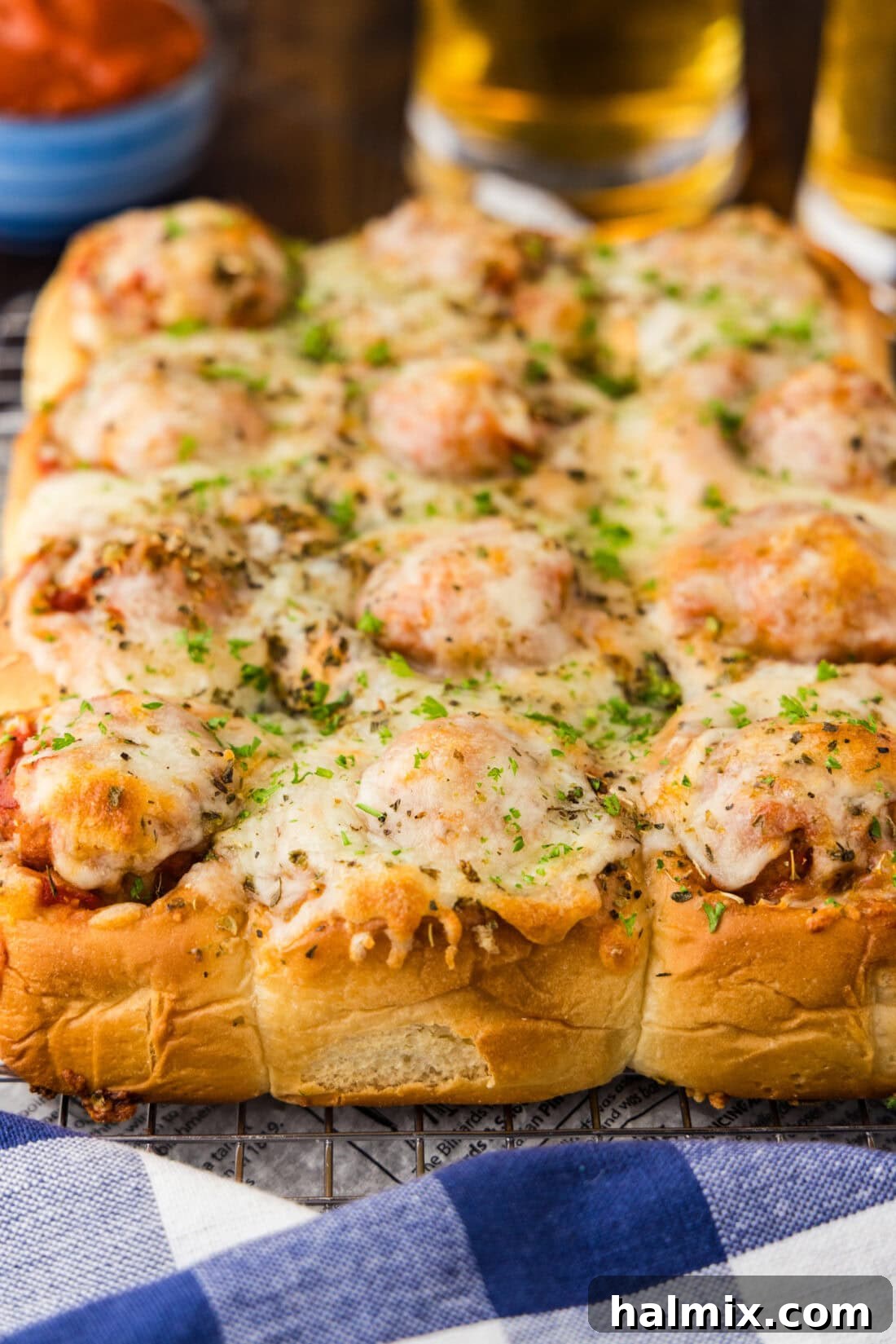 Pocket-Sized Meatball Delights 10 Close-up photo of several perfectly baked Meatball Sliders, showing the melted cheese and juicy meatballs within.