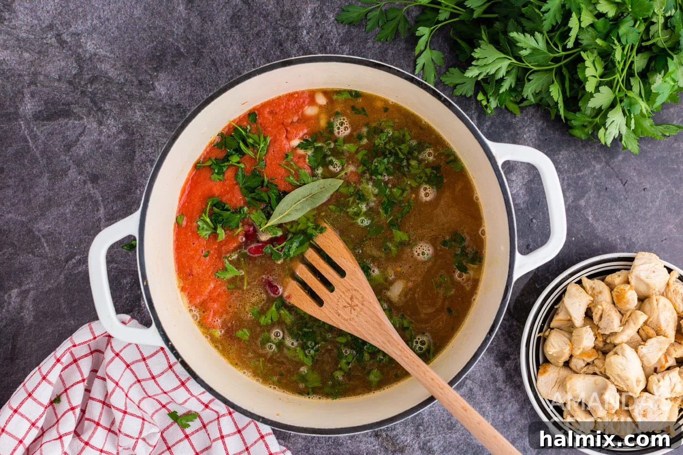 All soup ingredients, excluding chicken, added to the Dutch oven and brought to a boil, ready for simmering.
