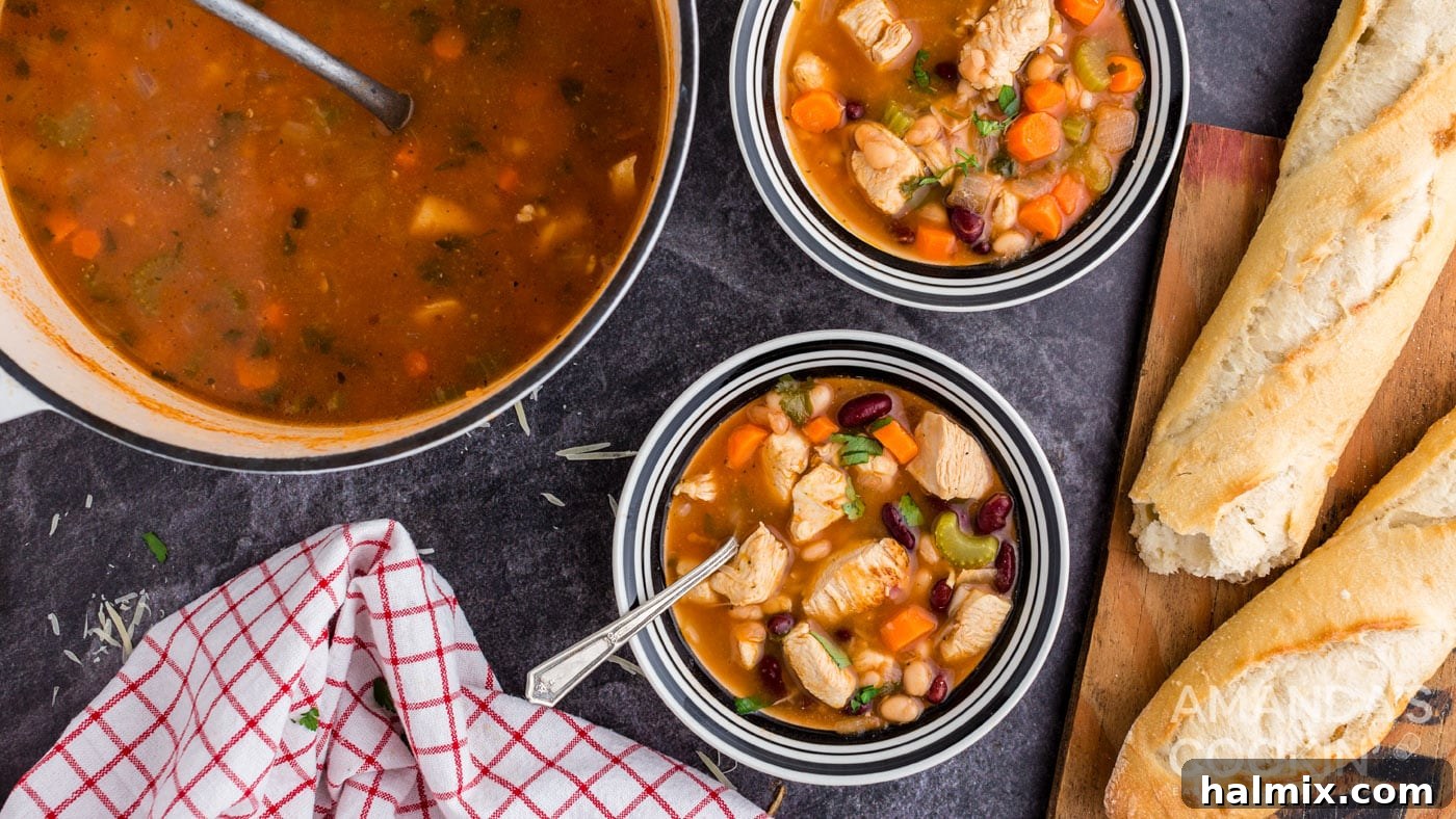 Multiple bowls of chicken bean soup, steaming hot and garnished, ready to be enjoyed.