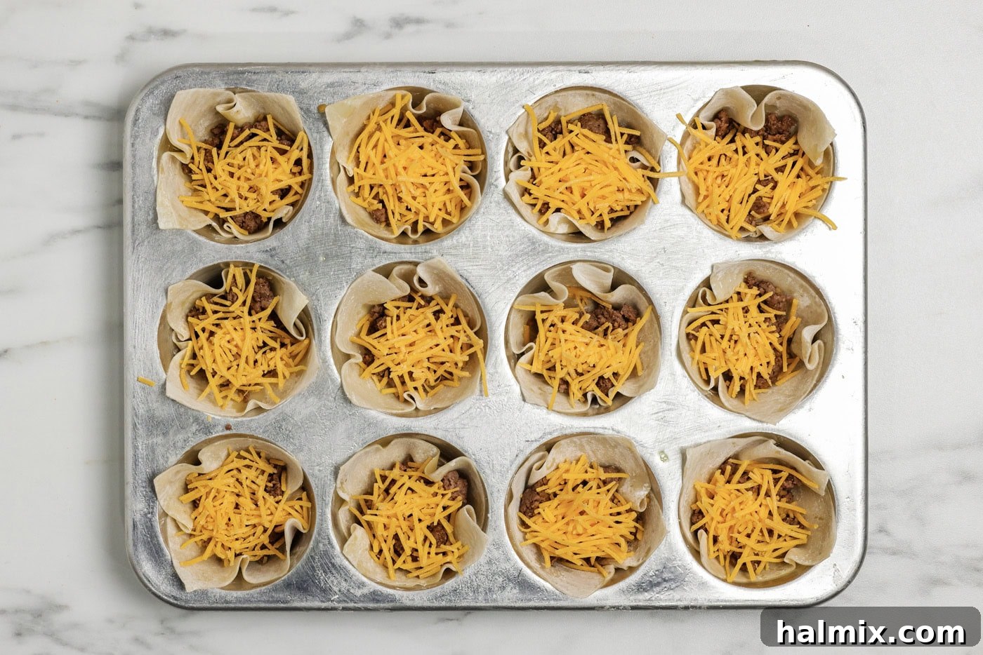Mini Taco Bites 7 Shredded cheese added on top of the taco meat inside wonton wrappers