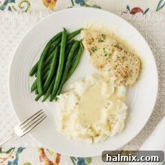Garlic Parmesan Chicken plated with mashed potatoes and green beans