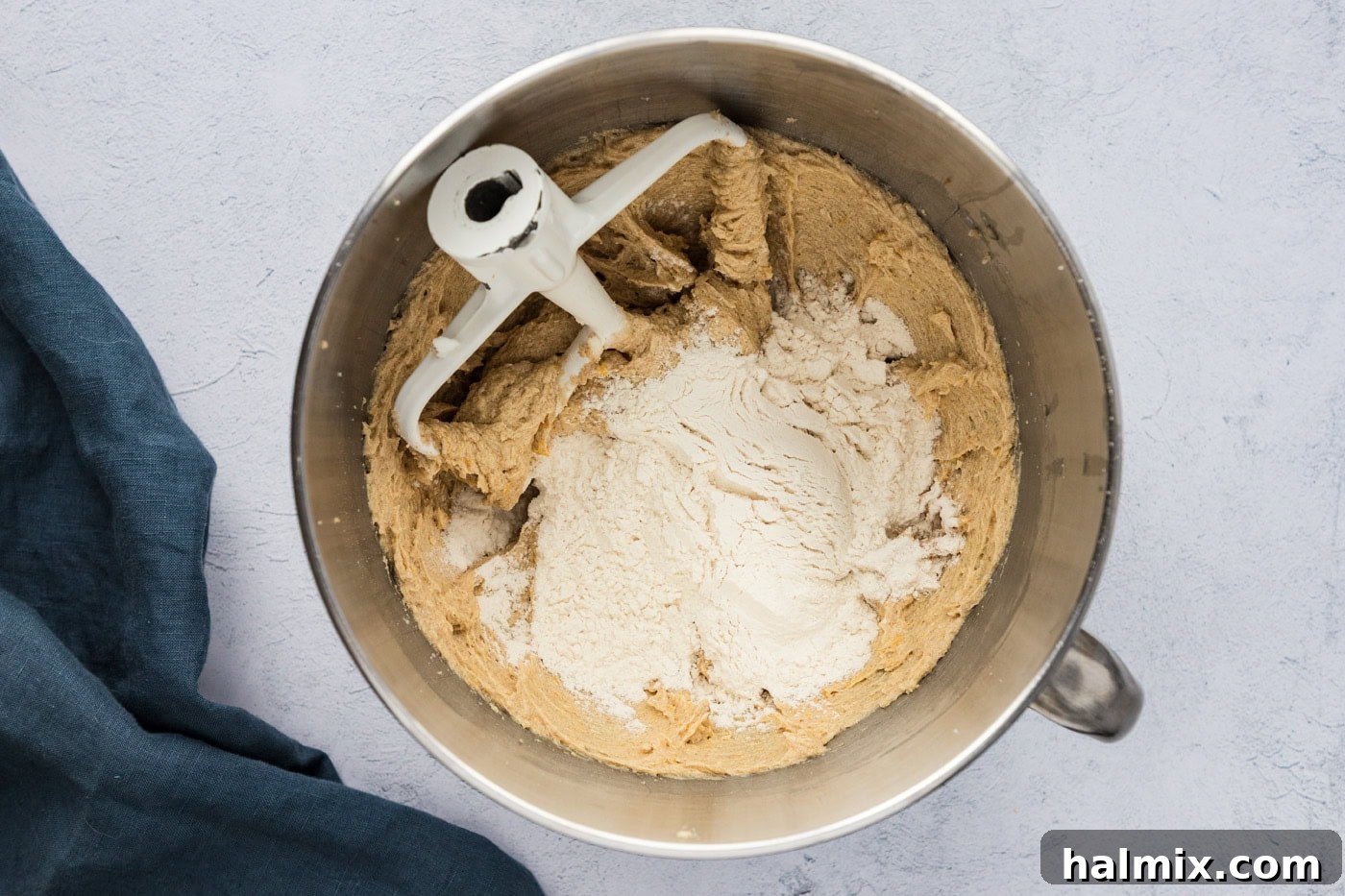 flour mixture added to creamed butter and sugars in a stand mixer bowl