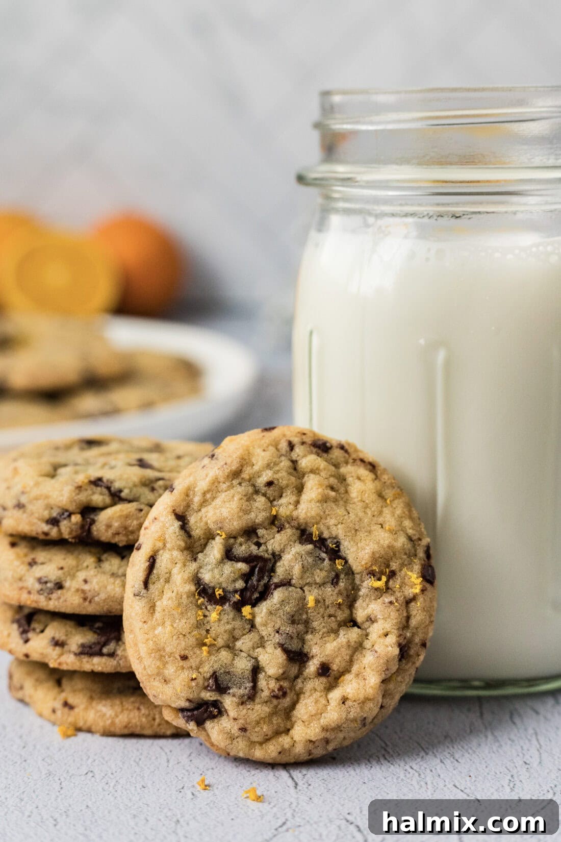 Orange Chocolate Chip Cookies resting against a glass of milk