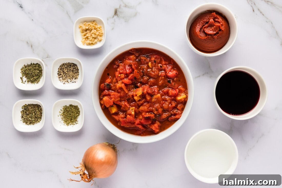 Classic Marinara Sauce 4 A rustic display of fresh ingredients laid out, including canned tomatoes, fresh herbs, garlic cloves, and an onion, all essential for making marinara sauce.