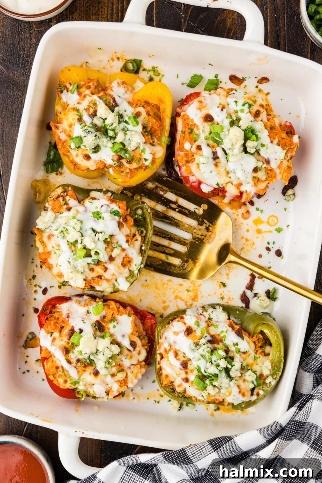 Zesty Buffalo Chicken Bell Pepper Bake 2 Five Buffalo Chicken Stuffed Peppers in a dish with a spatula