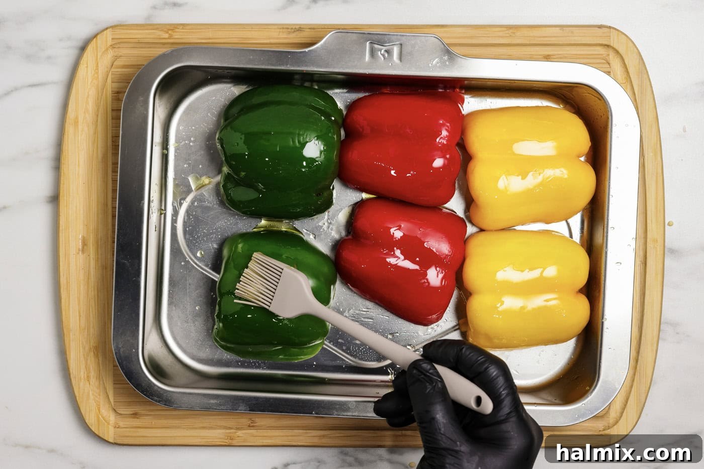 Zesty Buffalo Chicken Bell Pepper Bake 5 brushing bell peppers halves with olive oil on a baking sheet