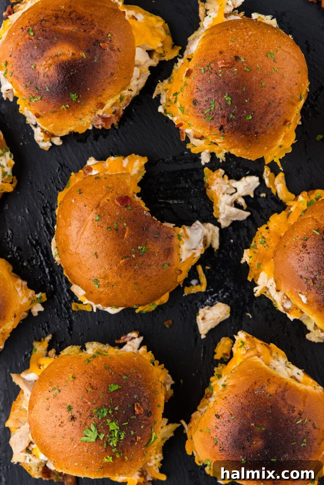 Overhead shot of Chicken Bacon Ranch Sliders, one with a bite taken out