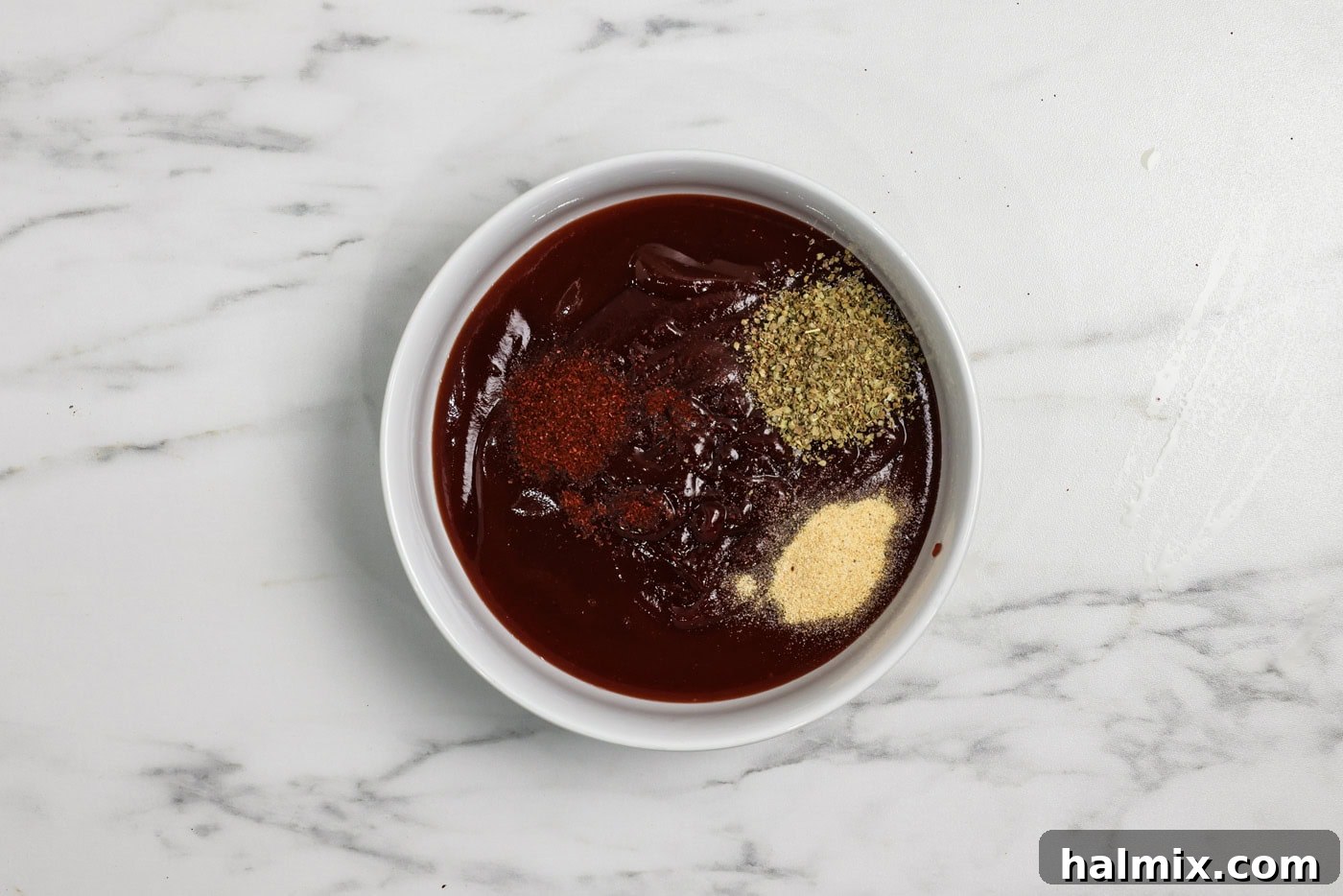 spices and seasonings in a bowl with barbecue sauce