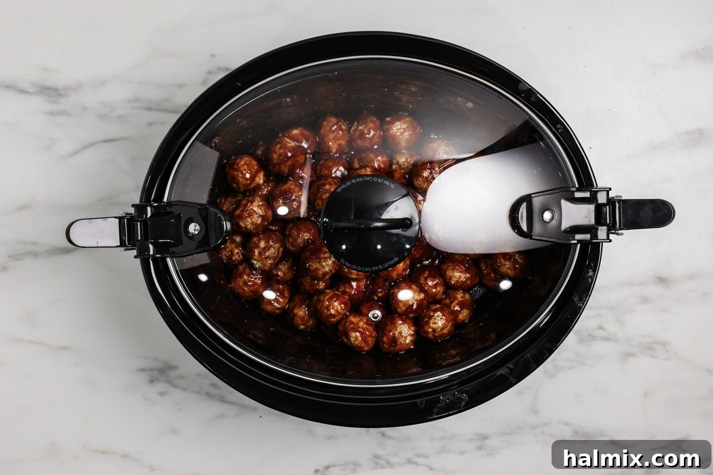 Barbecue meatballs in a crockpot covered with a lid