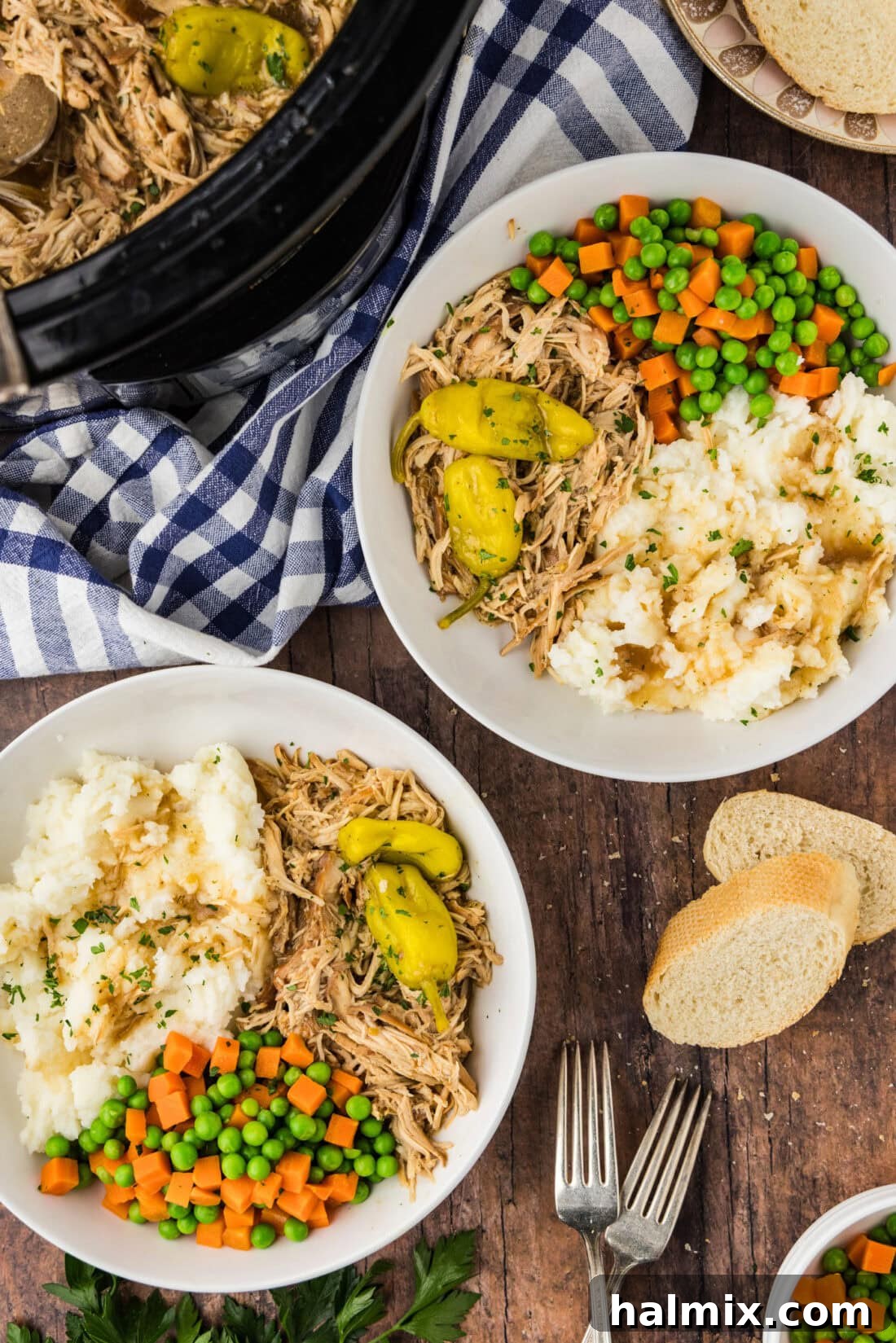 Two bowls of Mississippi Chicken with veggies and mashed potatoes on the side