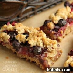 A close up photo of two berrylicious bars, highlighting the fruit and crumbly topping.