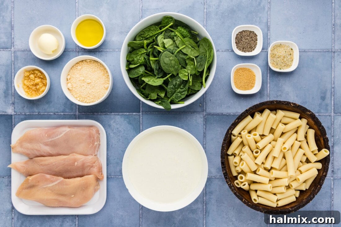 A selection of fresh ingredients laid out for making Garlic Chicken Pasta.