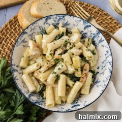 Plate of Creamy Garlic Chicken Pasta, garnished with fresh herbs.