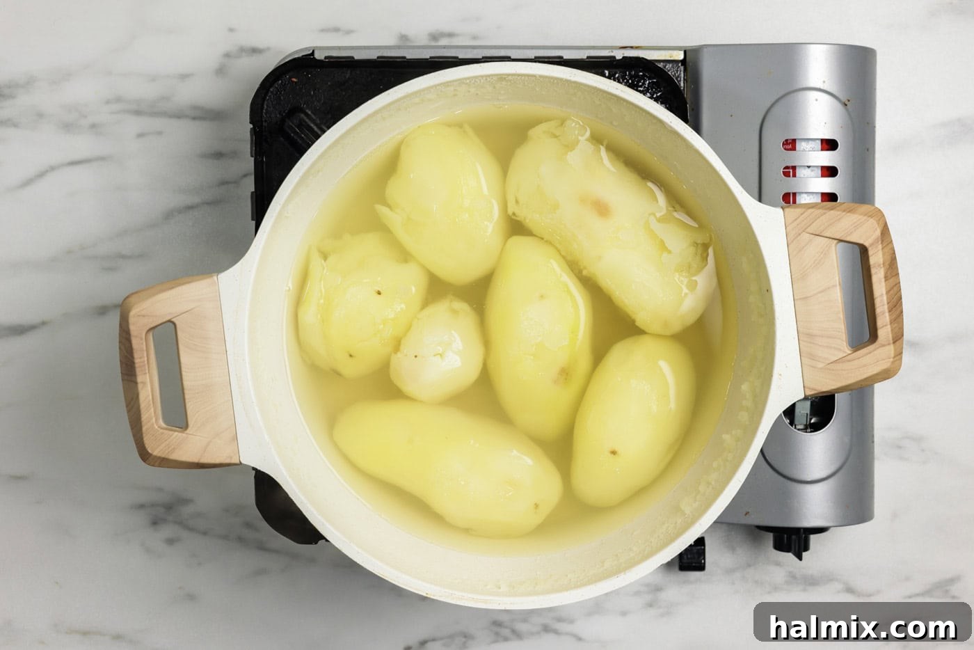 Colcannon: Ireland's Signature Mash 5 Peeled potatoes in a stockpot with water, ready for boiling.