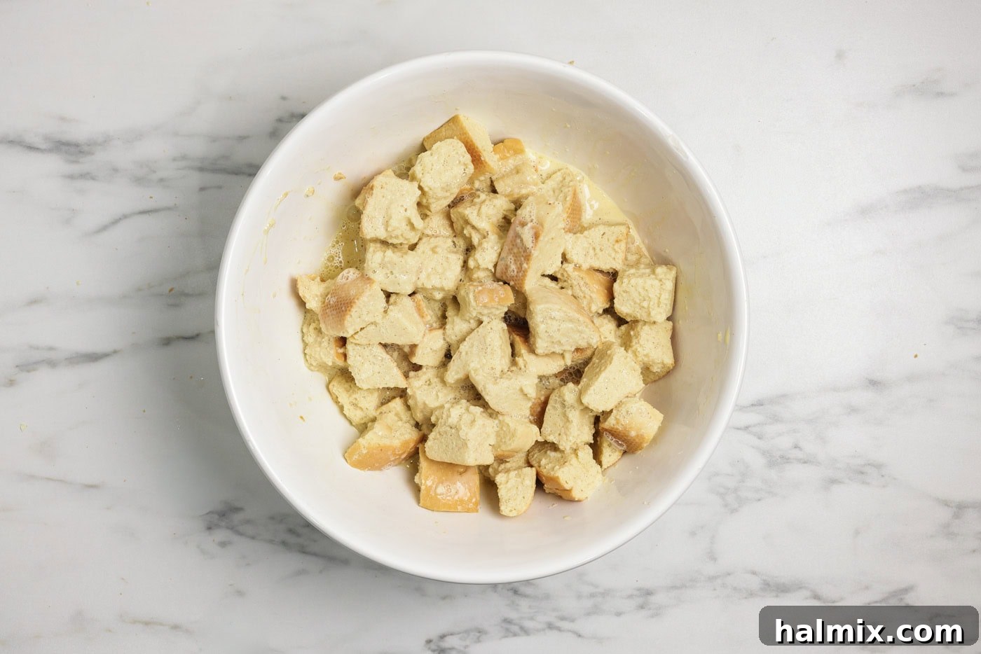 cubed bread in a bowl with custard filling