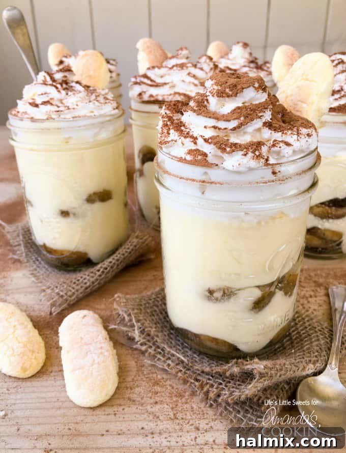 A close-up photo of tiramisu trifles in mason jars, highlighting the intricate layers.