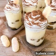 A photo of tiramisu trifles in mason jars.