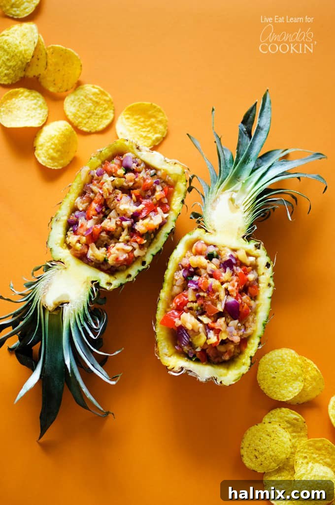 An overhead photo of pineapple salsa served in halved pineapples, highlighting the vibrant colors and fresh ingredients.