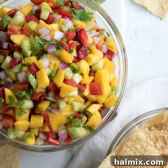 A photo of pineapple salsa in a clear bowl, ready to be served.