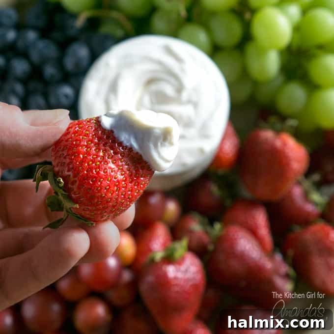 Cream Cheese Fruit Dip served in a bowl with various fresh fruits around it.