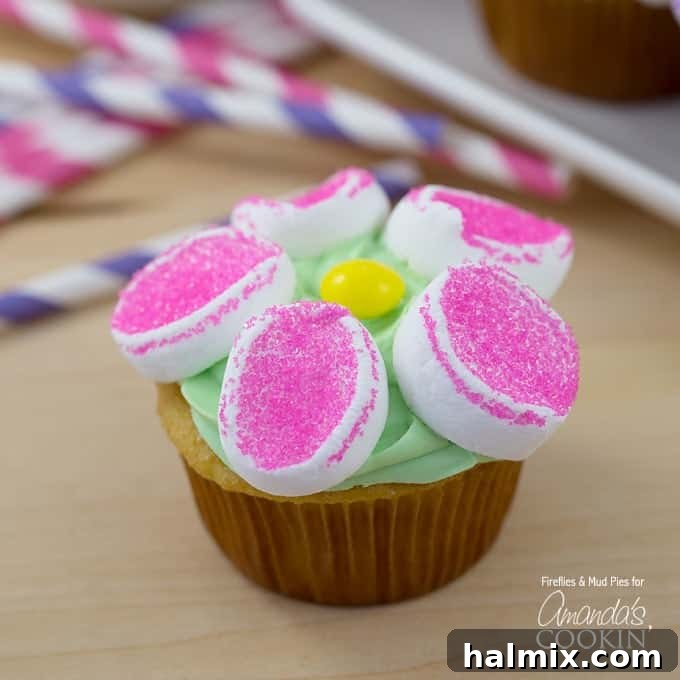 Marshmallow Blossom Cupcakes 2 A close up of a marshmallow flower cupcake, showcasing the vibrant colors and delicate marshmallow petals.