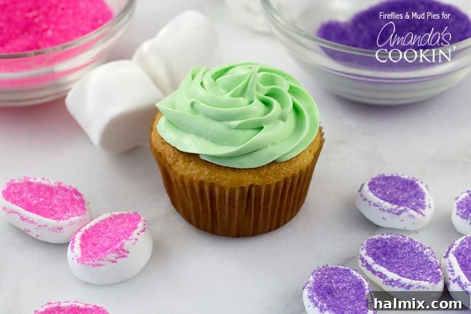 Marshmallow Blossom Cupcakes 3 A perfectly frosted cupcake with light green icing, ready for decoration.