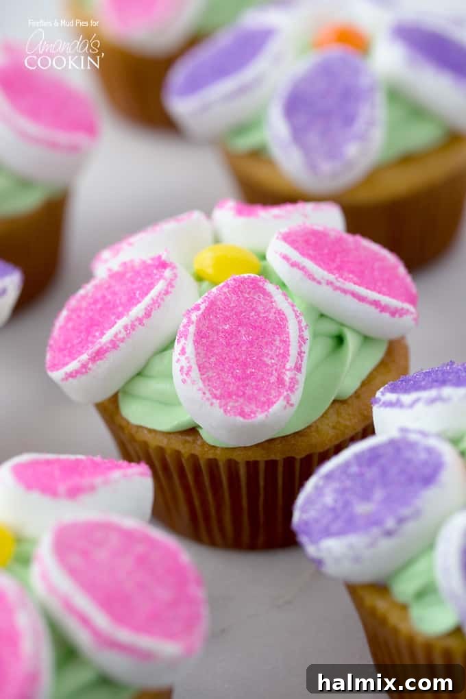 Marshmallow Blossom Cupcakes 6 A vibrant display of marshmallow flower cupcakes, glistening with sanding sugar.