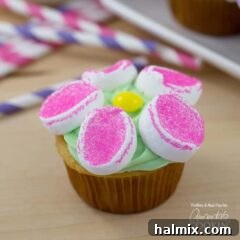 A close up of a marshmallow flower cupcake, showcasing the vibrant colors and delicate marshmallow petals.