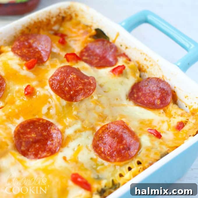 Layered Pizza Bake 16 A close up photo of the finished, baked pizza lasagna in a blue casserole dish, ready to be served.