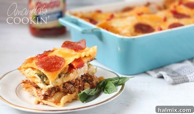 Layered Pizza Bake 18 A close up of pizza lasagna on a white and gold plate with the full dish in the background, ready for serving.