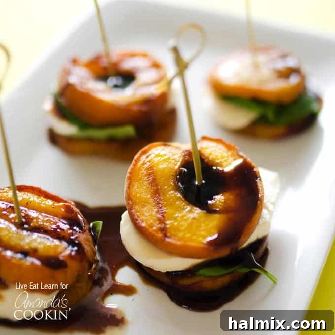 A close up of grilled peach caprese on a white platter, showcasing the vibrant colors and fresh ingredients of the summer appetizer.