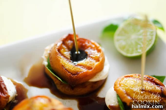 A close up of individual grilled peach caprese stacks, ready to be served as a delightful summer appetizer.