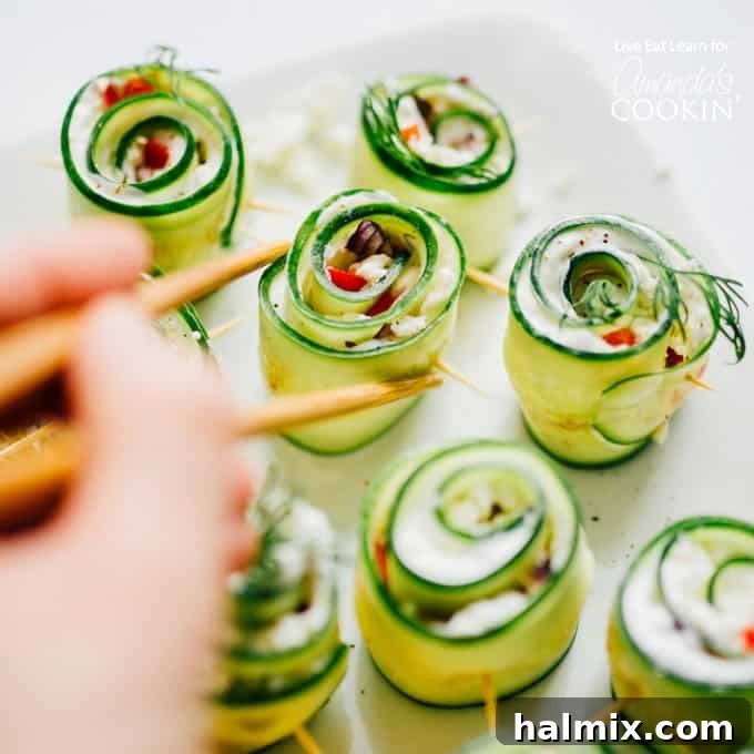 Picking up cucumber sushi with chopsticks, showcasing a healthy and vibrant snack.