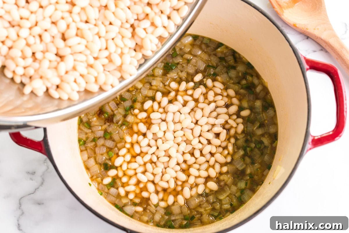 adding beans to onion mixture in pan